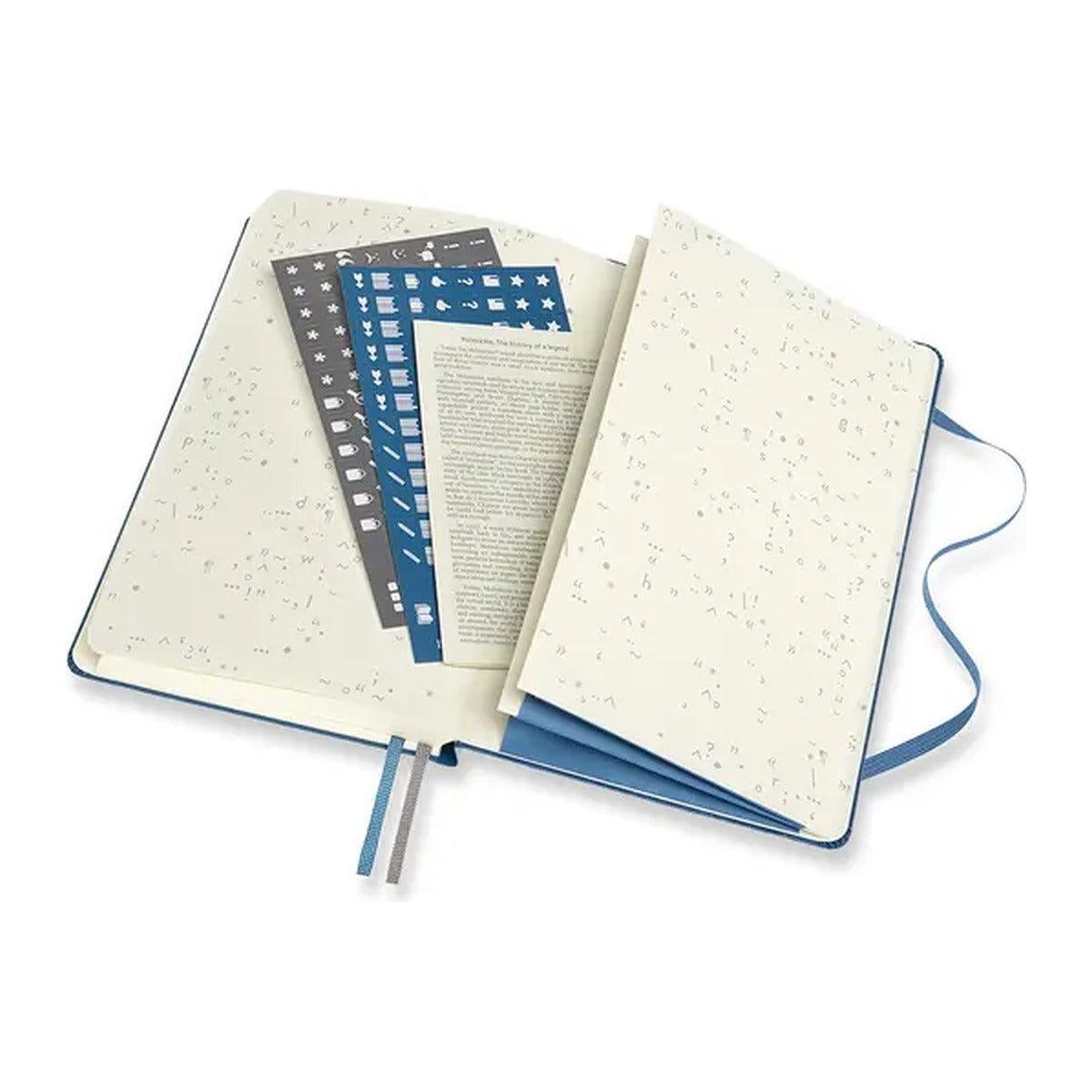 Opengeslagen Moleskine Book Journal met stickervellen en uitvouwbare pagina